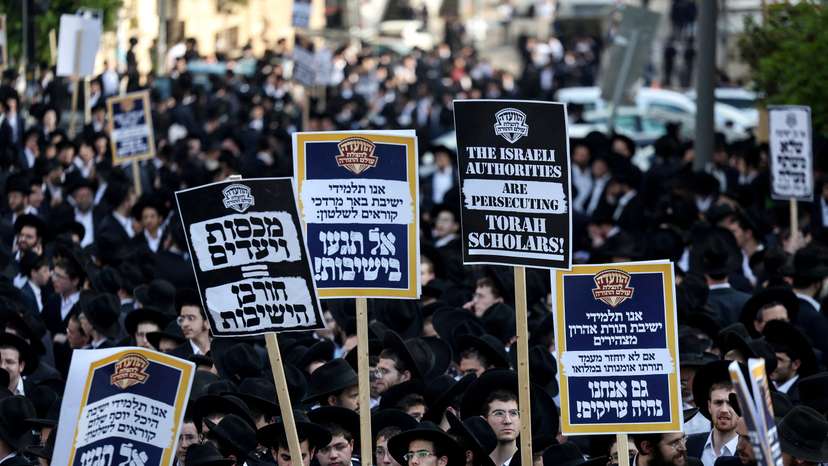 FILE PHOTO: Ultra-Orthodox Jewish men protest against attempts to change government policy that grants ultra-Orthodox Jews exemptions from military conscription, in Jerusalem