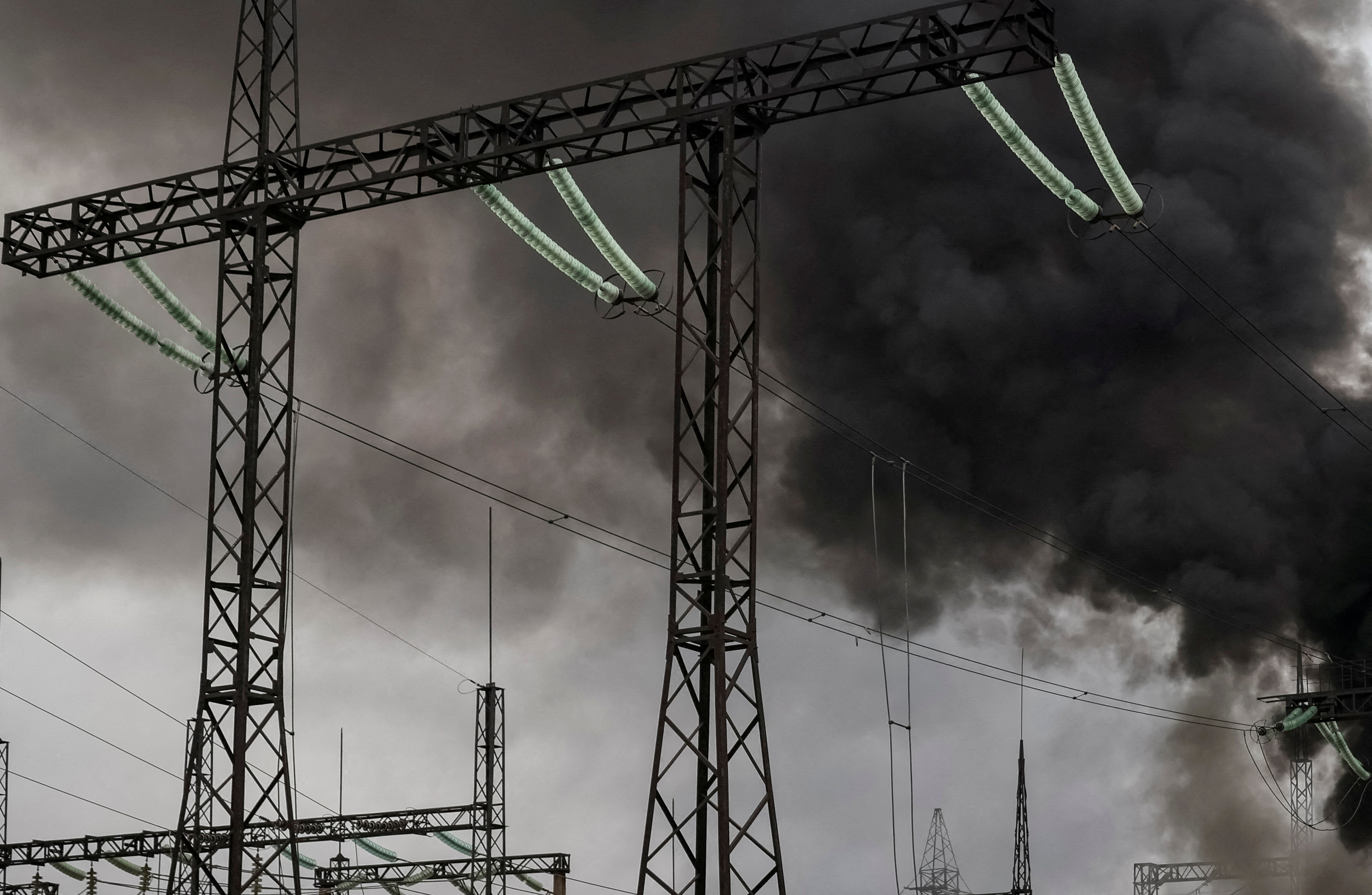 FILE PHOTO: Smoke rises above a high-voltage power line after a Russian missile strike outside Kharkiv in Ukraineside Kharkiv