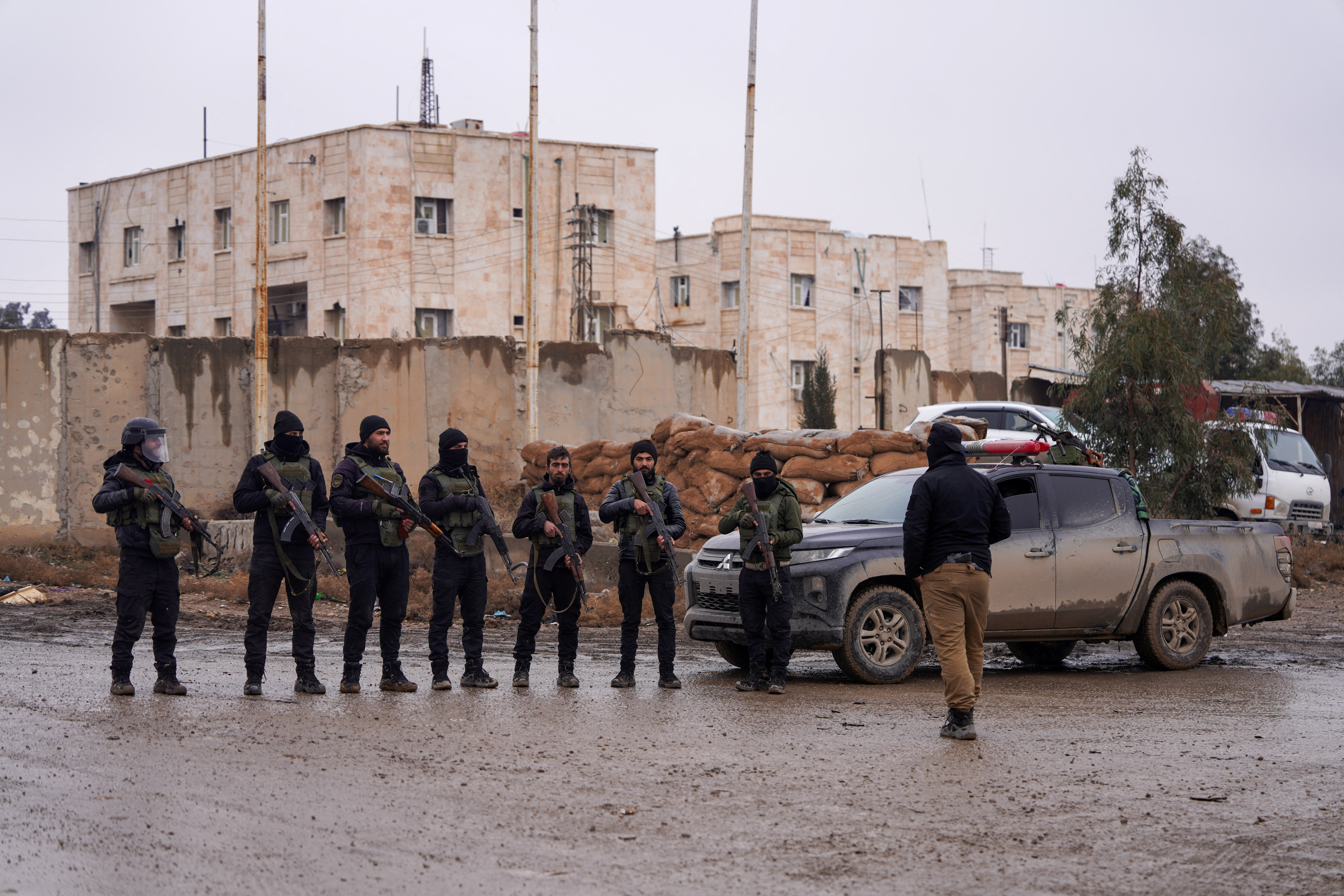 Syrian security forces outside al-Aqtan prison, where some Islamic State detainees are held, in Raqqa