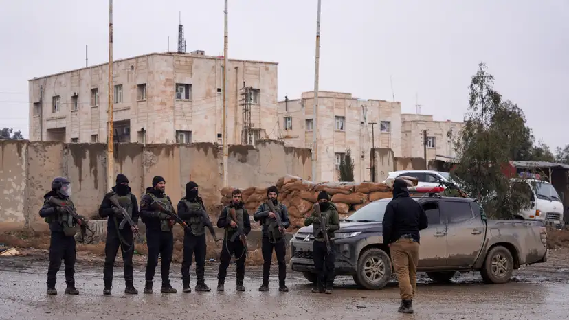 Syrian security forces outside al-Aqtan prison, where some Islamic State detainees are held, in Raqqa