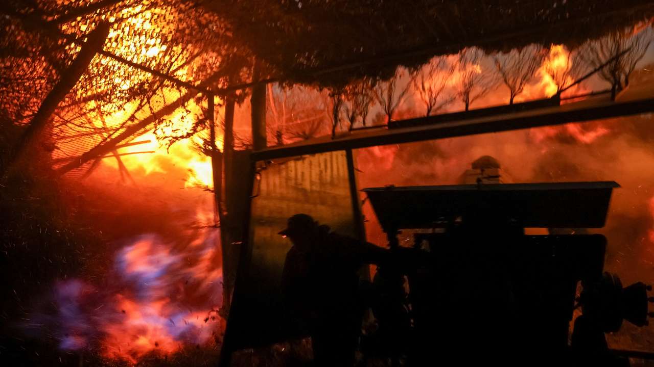 Ukrainian serviceman fires a howitzer towards Russian troops near the frontline town of Kupiansk