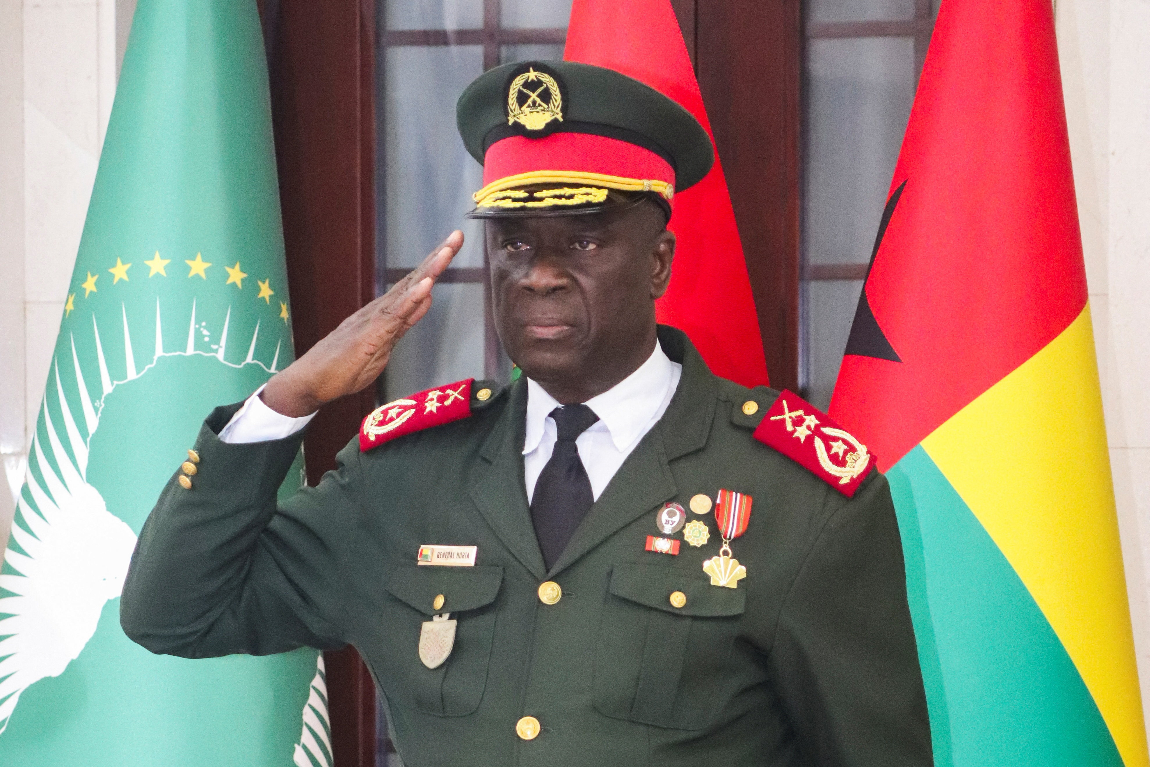 Major-General Horta Inta-a, the new transitional president, salutes during the swearing-in ceremony of Major-General Tomas Djassi in Bissau