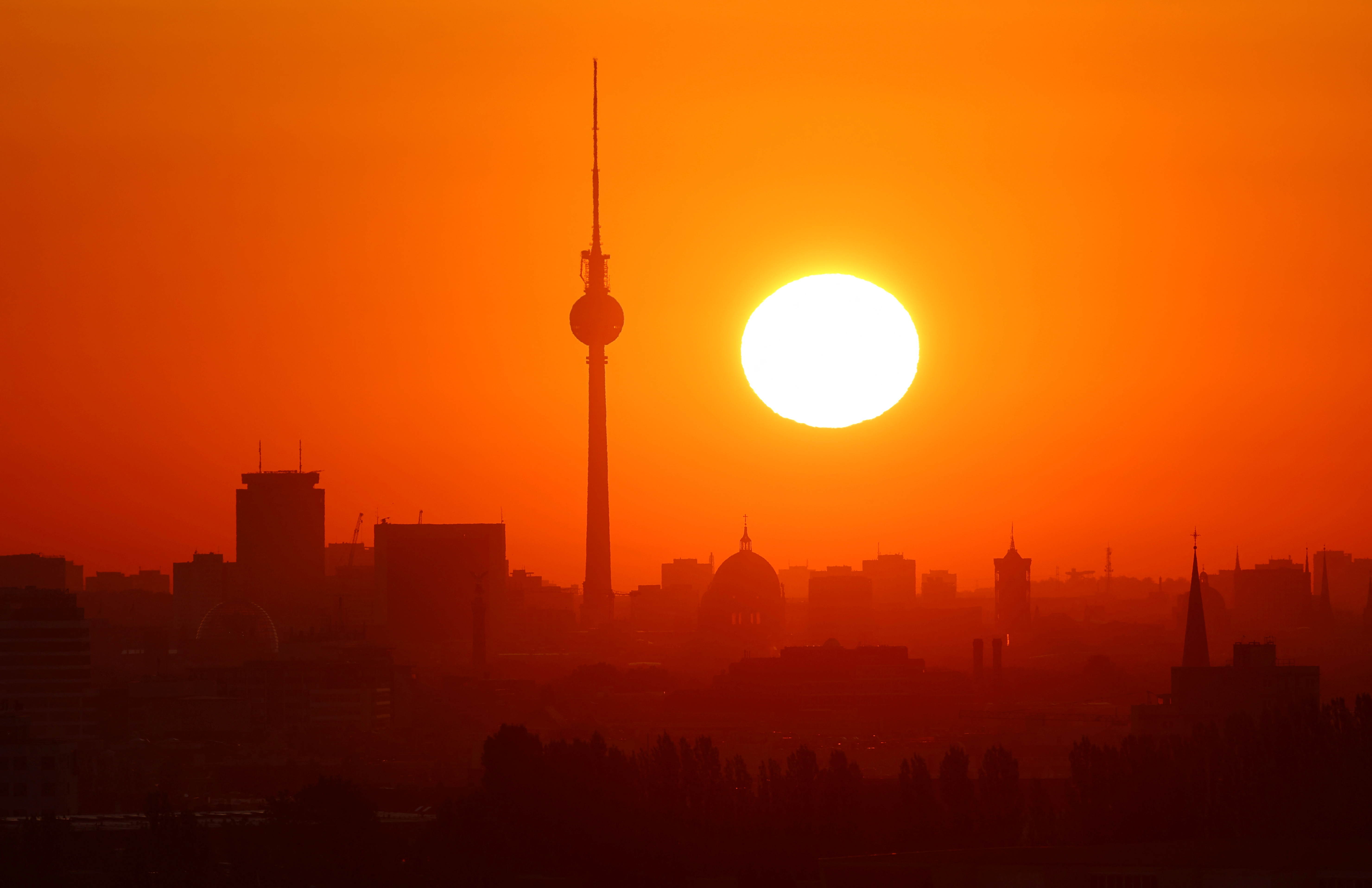 Sun rises behind the skyline of Berlin