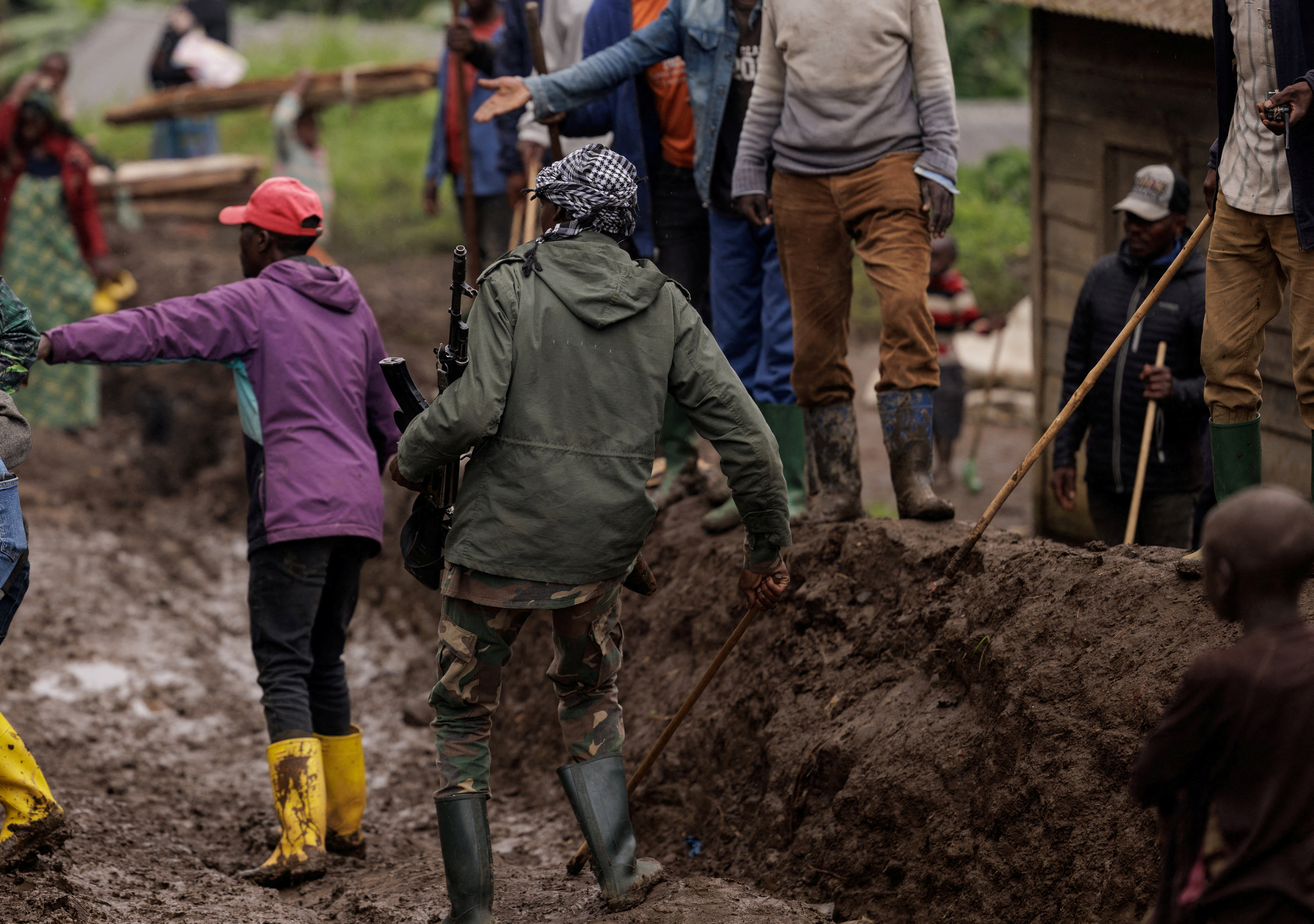 FILE PHOTO: An M23 rebel walks on a muddy road on the outskirts of Rubaya