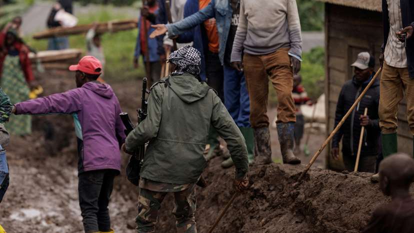 FILE PHOTO: An M23 rebel walks on a muddy road on the outskirts of Rubaya