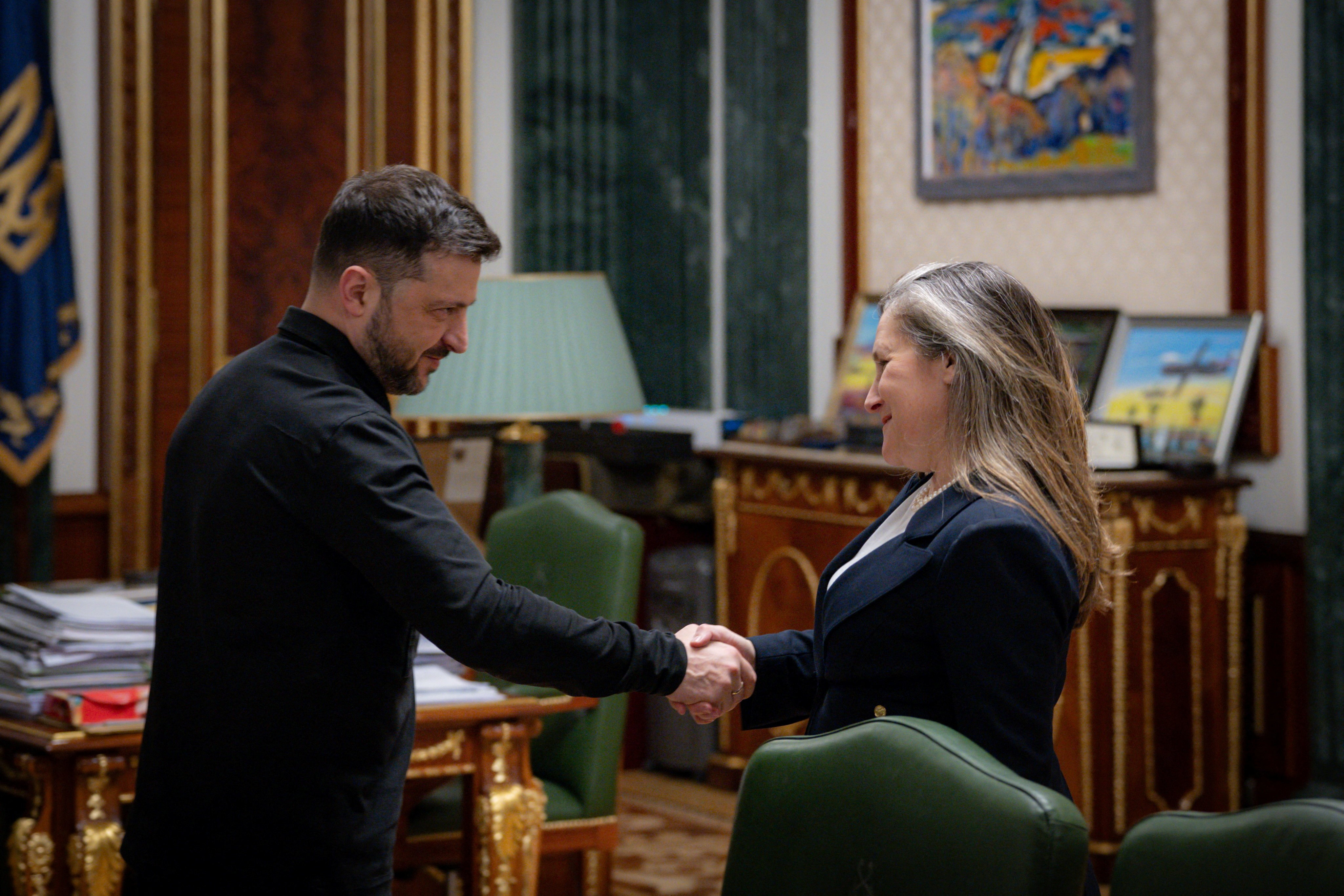 Ukraine's President Volodymyr Zelenskiy and former Canada's Minister of Transport and Internal Trade Freeland shake hands during their meeting in Kyiv