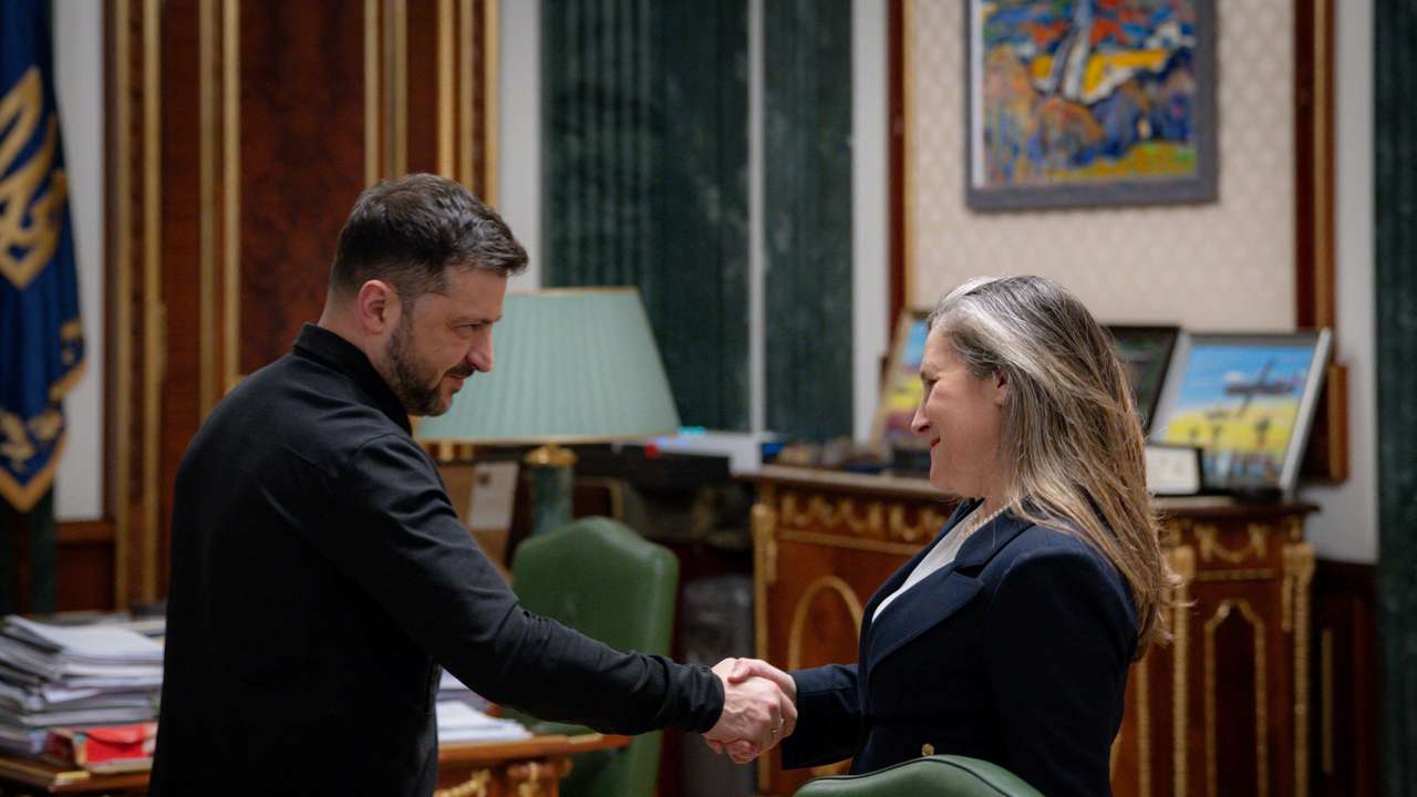 Ukraine's President Volodymyr Zelenskiy and former Canada's Minister of Transport and Internal Trade Freeland shake hands during their meeting in Kyiv