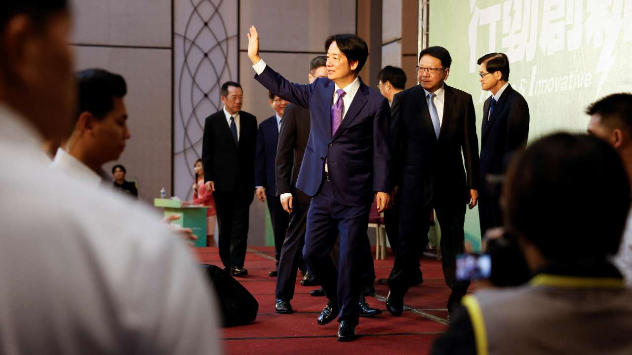 Taiwan President-elect Lai Ching-te speaks waves during a press conference in Taipei