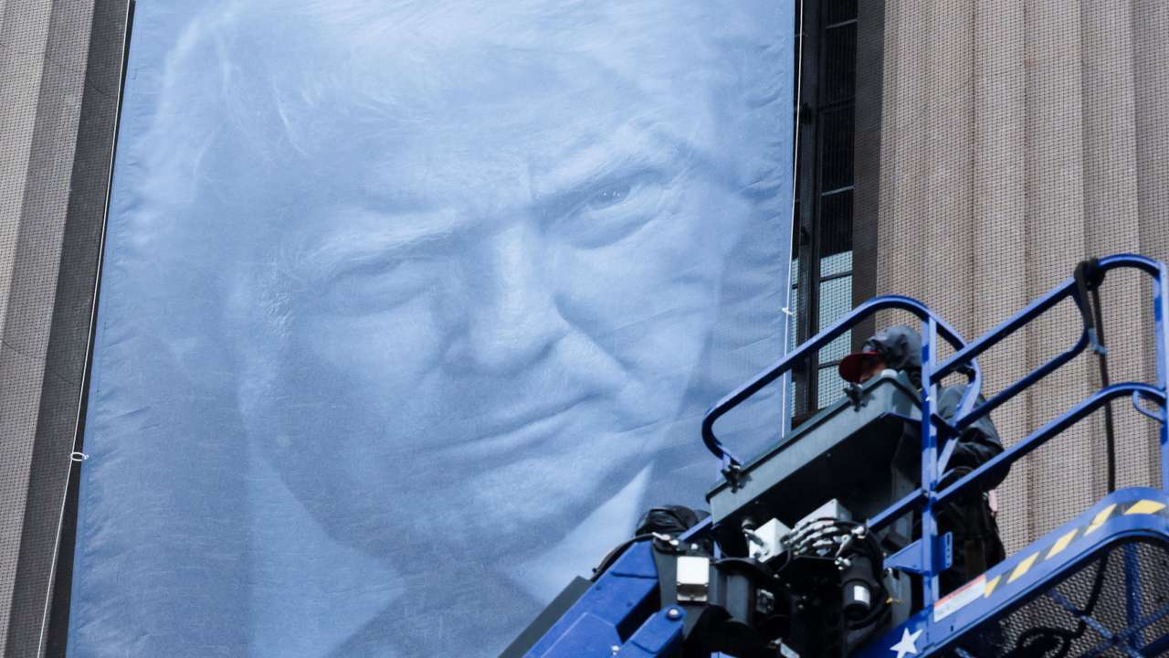 New banners depicting U.S. President Donald Trump are hung on the Department of Justice building in Washington