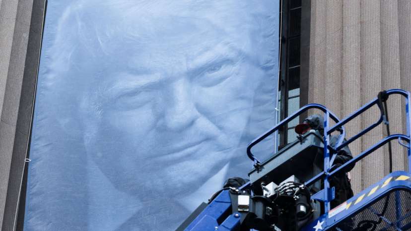 New banners depicting U.S. President Donald Trump are hung on the Department of Justice building in Washington