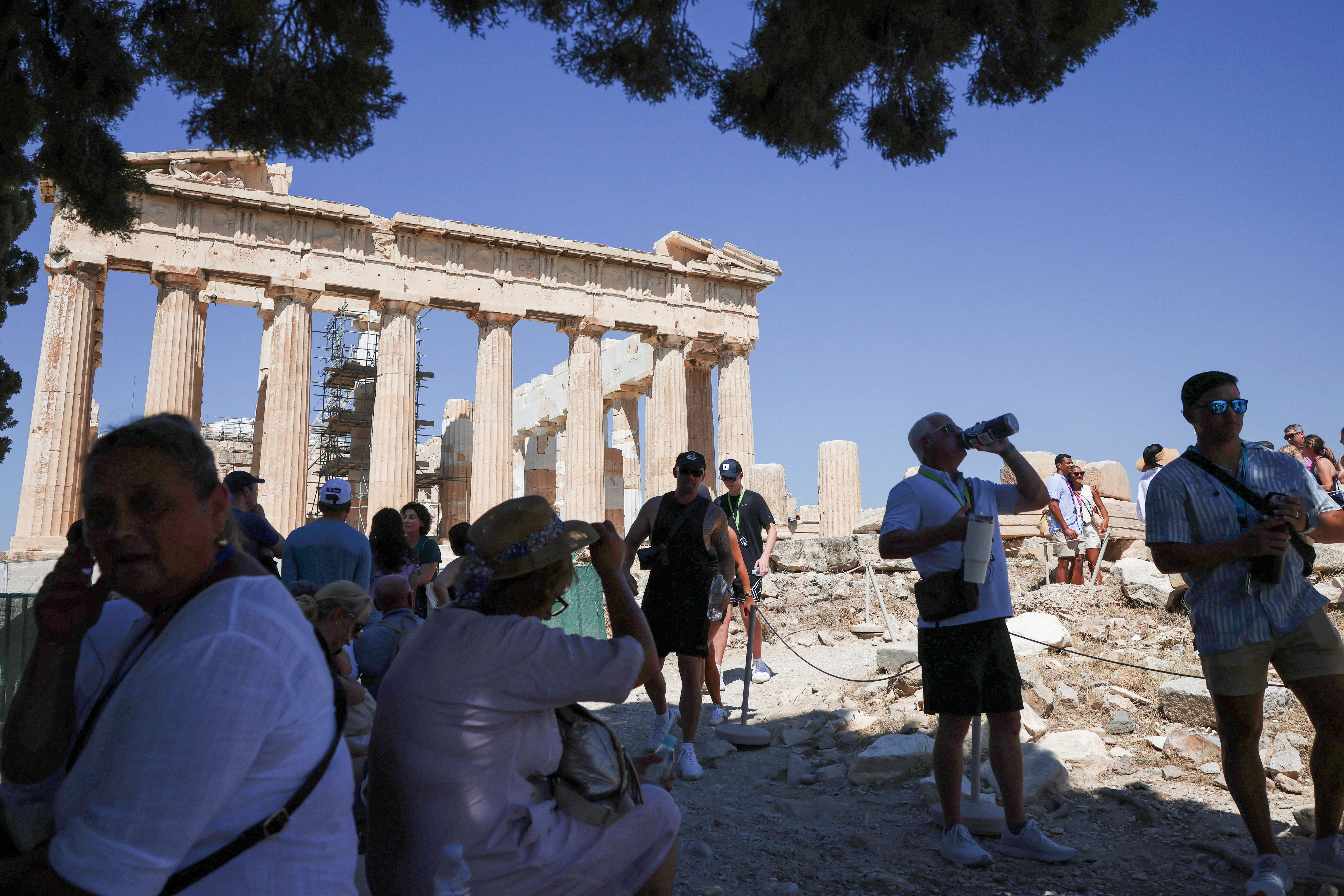 Tourists visit the Acropolis during a 3-days heatwave in Greece