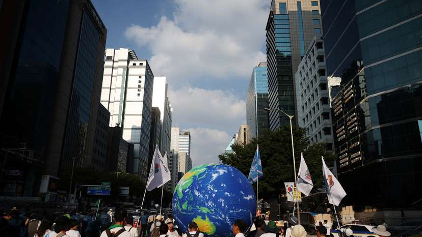 People take part in a climate justice rally in central Seoul