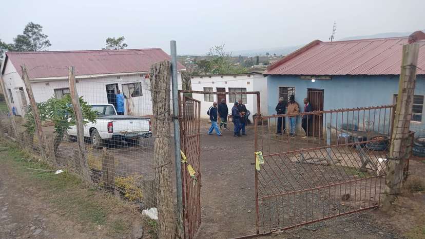 Police officials work at the scene of a mass shooting in Lusikisiki
