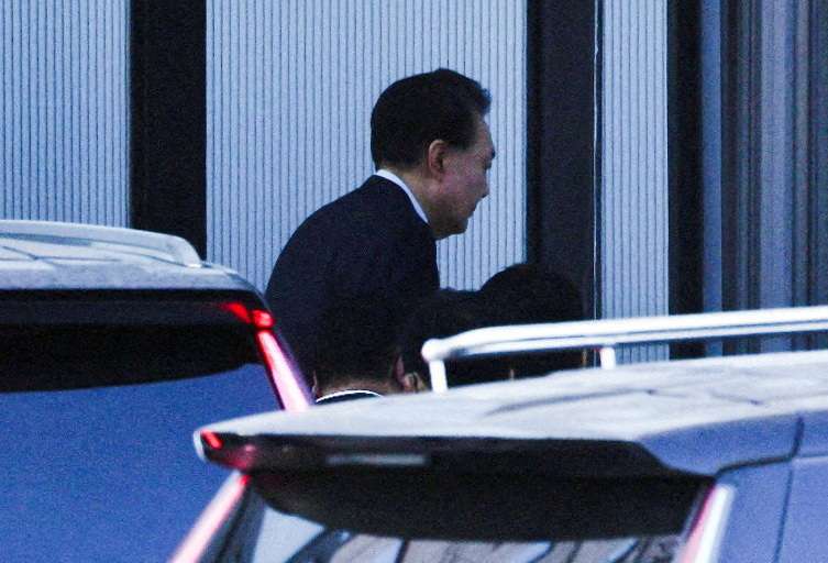 FILE PHOTO: South Korean investigators arrest impeached President Yoon