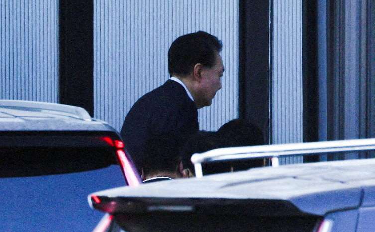FILE PHOTO: South Korean investigators arrest impeached President Yoon