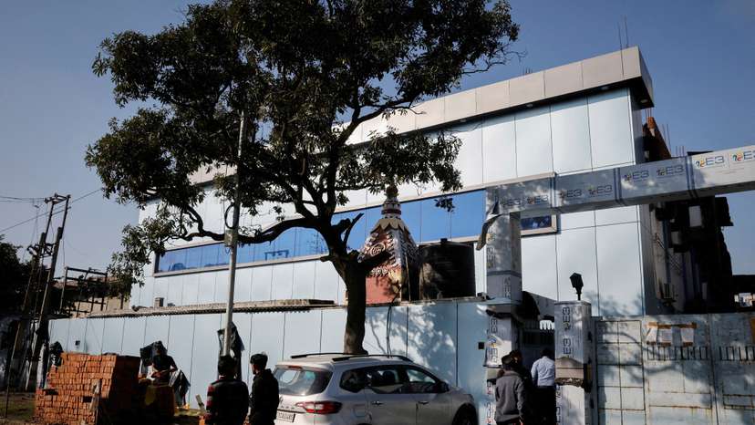 FILE PHOTO: People stand outside the Maiden Pharmaceuticals plant in Sonipat in the northern state of Haryana, India,
