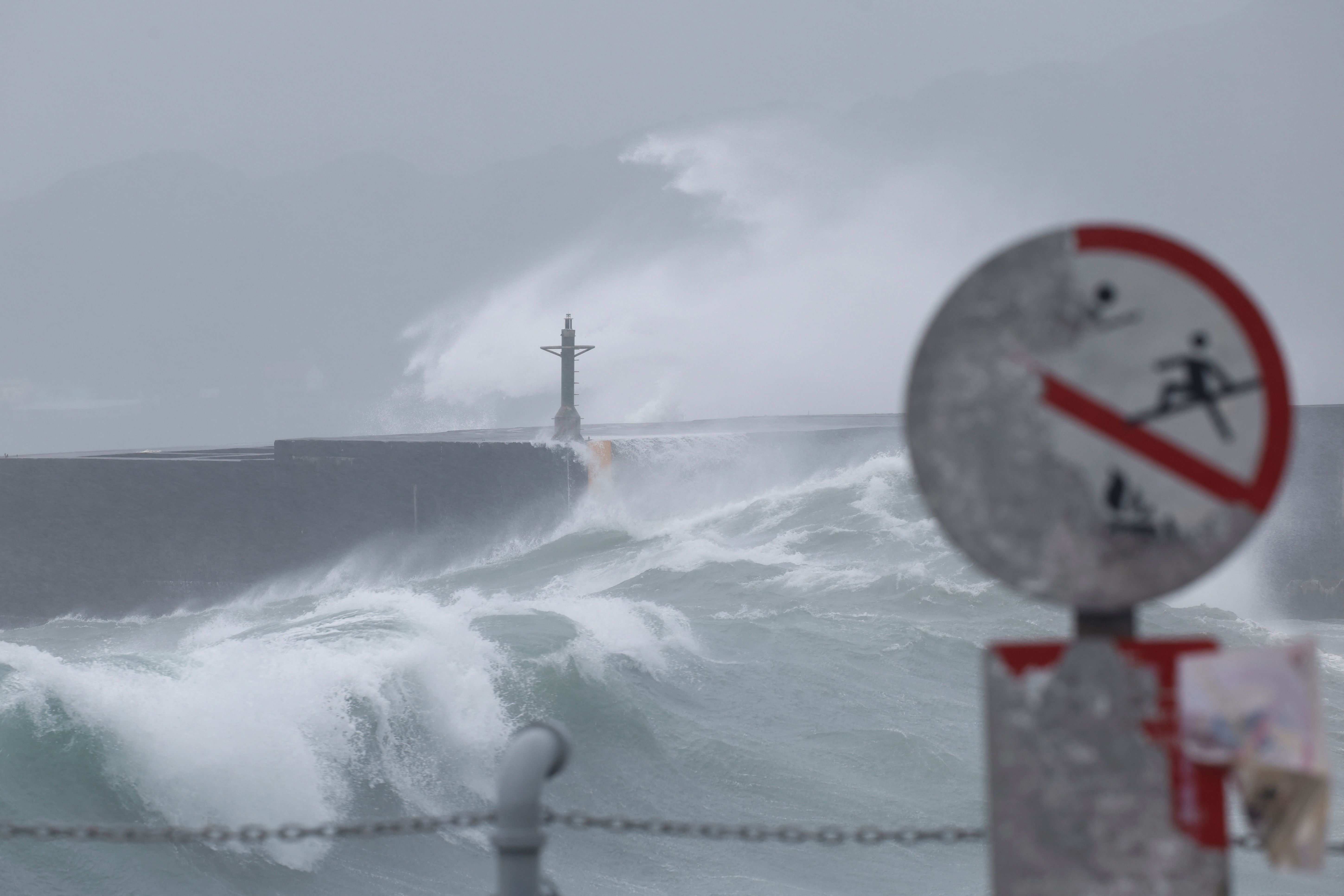 Waves break against the protecting walls as Typhoon Gaemi approaches in Keelung