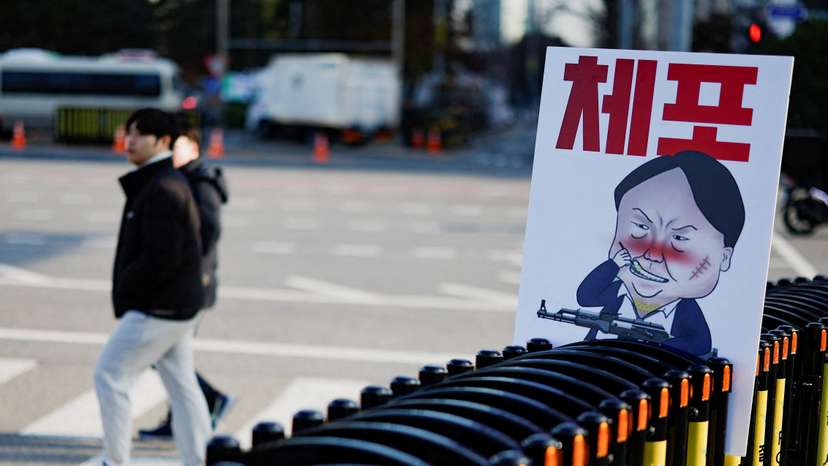 A pedestrian walks past a banner denouncing South Korean President Yoon Suk Yeol, in Seoul