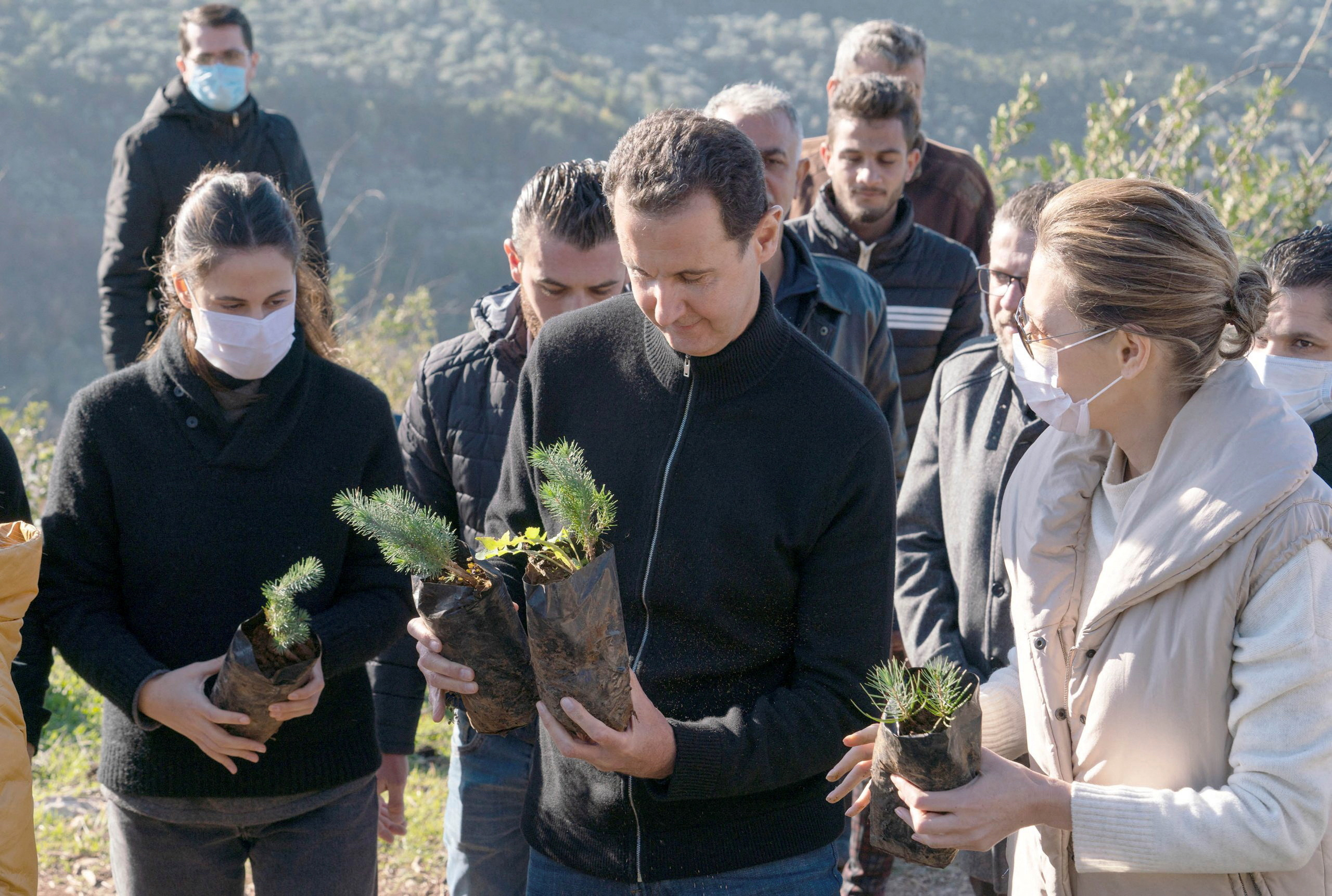 FILE PHOTO: Syria's President Bashar al-Assad and his wife Asma, plant trees in city of Draykish