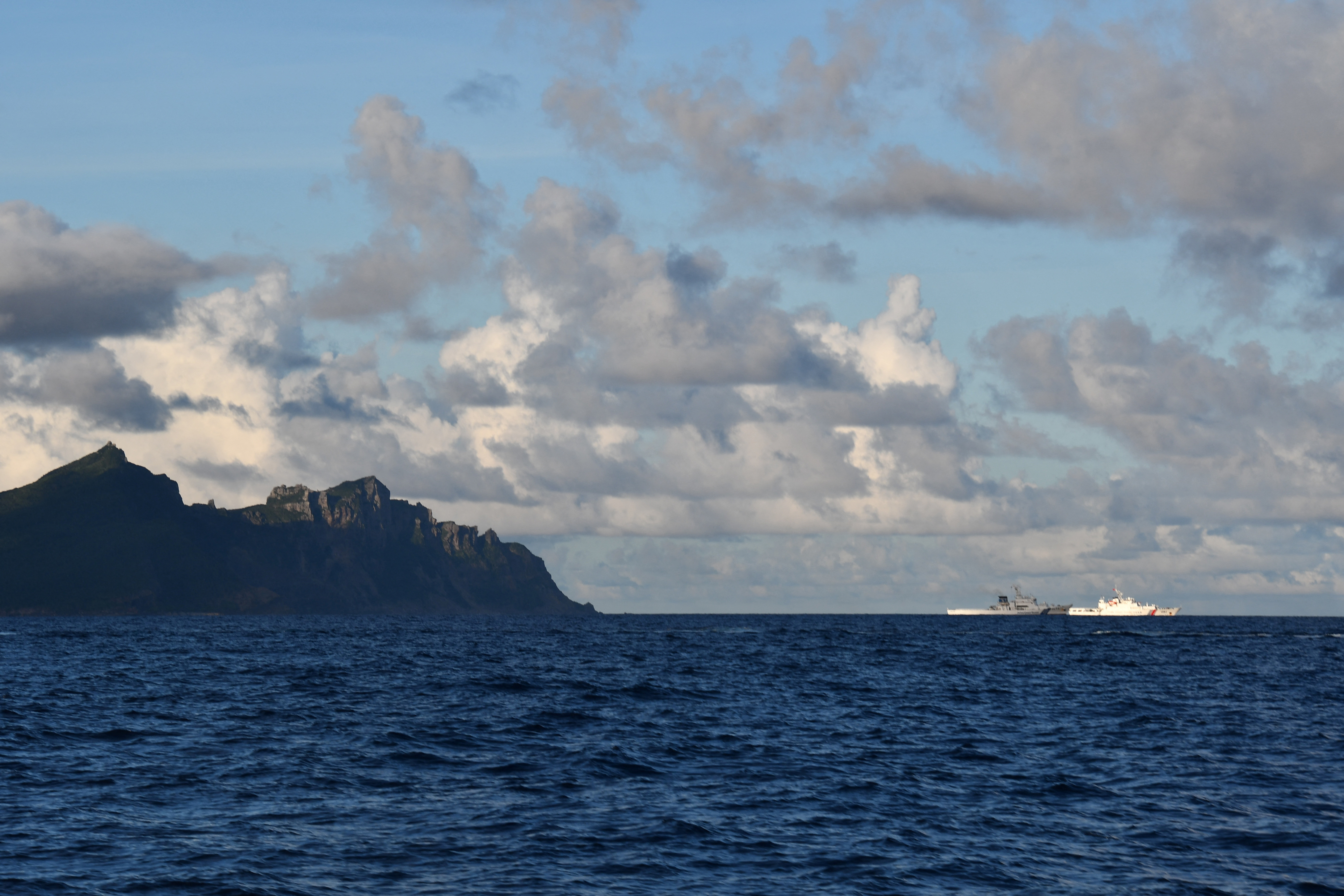 A China Coast Guard vessel sails near a Japan Coast Guard vessel around a group of disputed islands called Senkaku Islands in Japan, also known in China as Diaoyu Islands