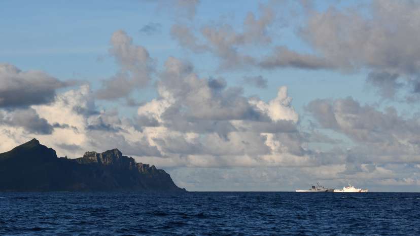 A China Coast Guard vessel sails near a Japan Coast Guard vessel around a group of disputed islands called Senkaku Islands in Japan, also known in China as Diaoyu Islands