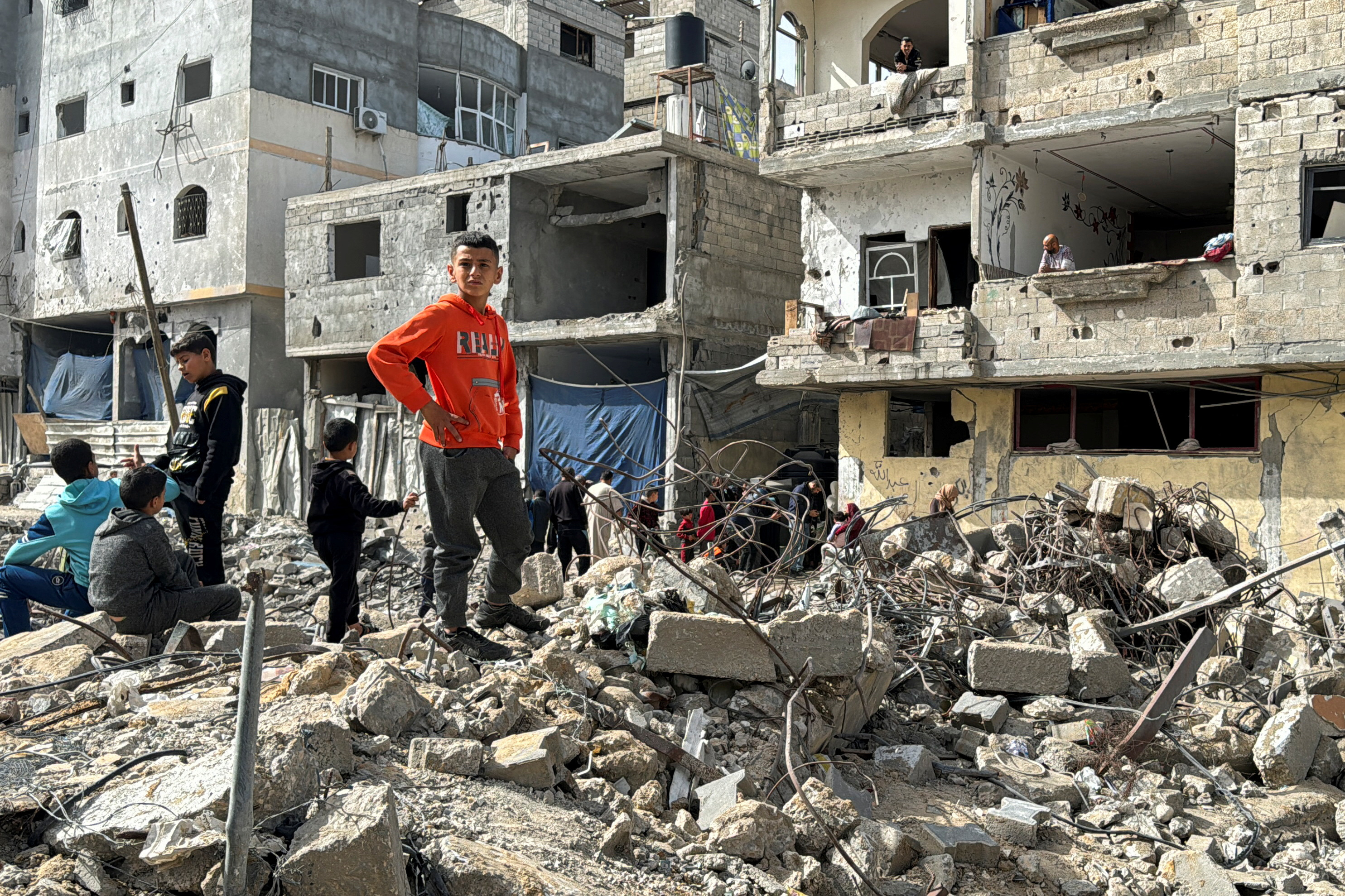 Palestinians inspect the site of an Israeli strike, in Rafah, in the southern Gaza Strip