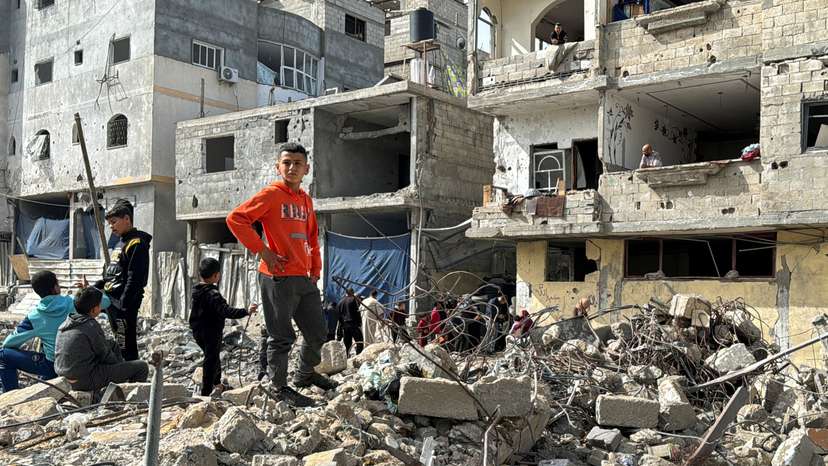 Palestinians inspect the site of an Israeli strike, in Rafah, in the southern Gaza Strip