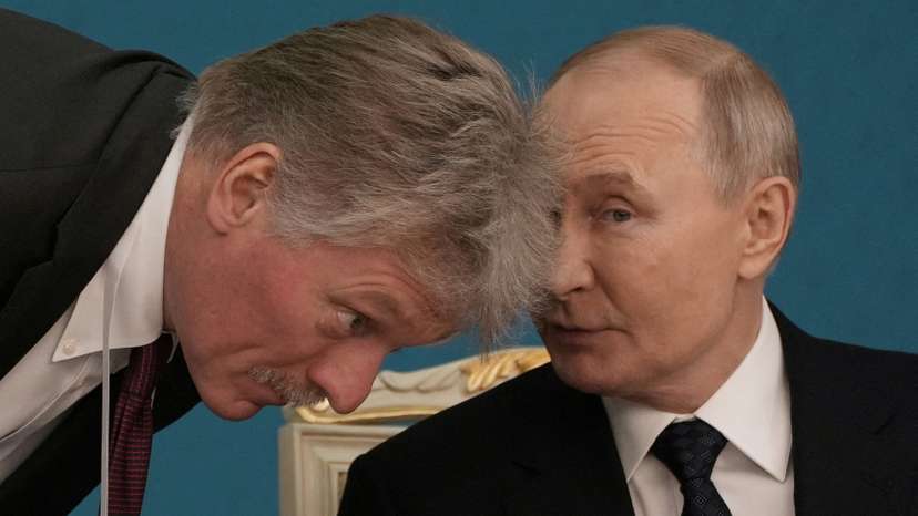FILE PHOTO: Russian President Vladimir Putin talks to Kremlin spokesman Dmitry Peskov