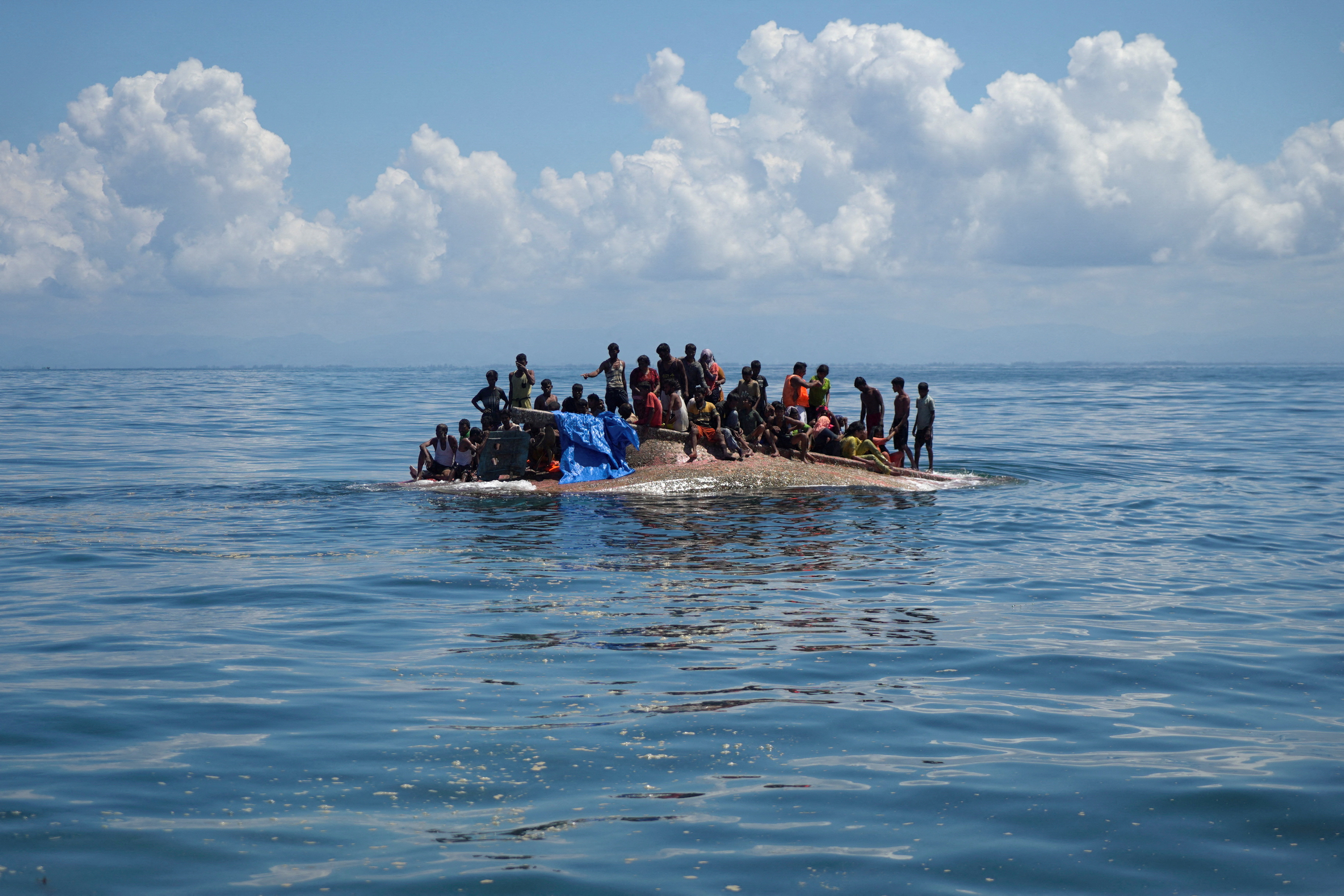 Rohingya refugees being rescued in the waters of West Aceh