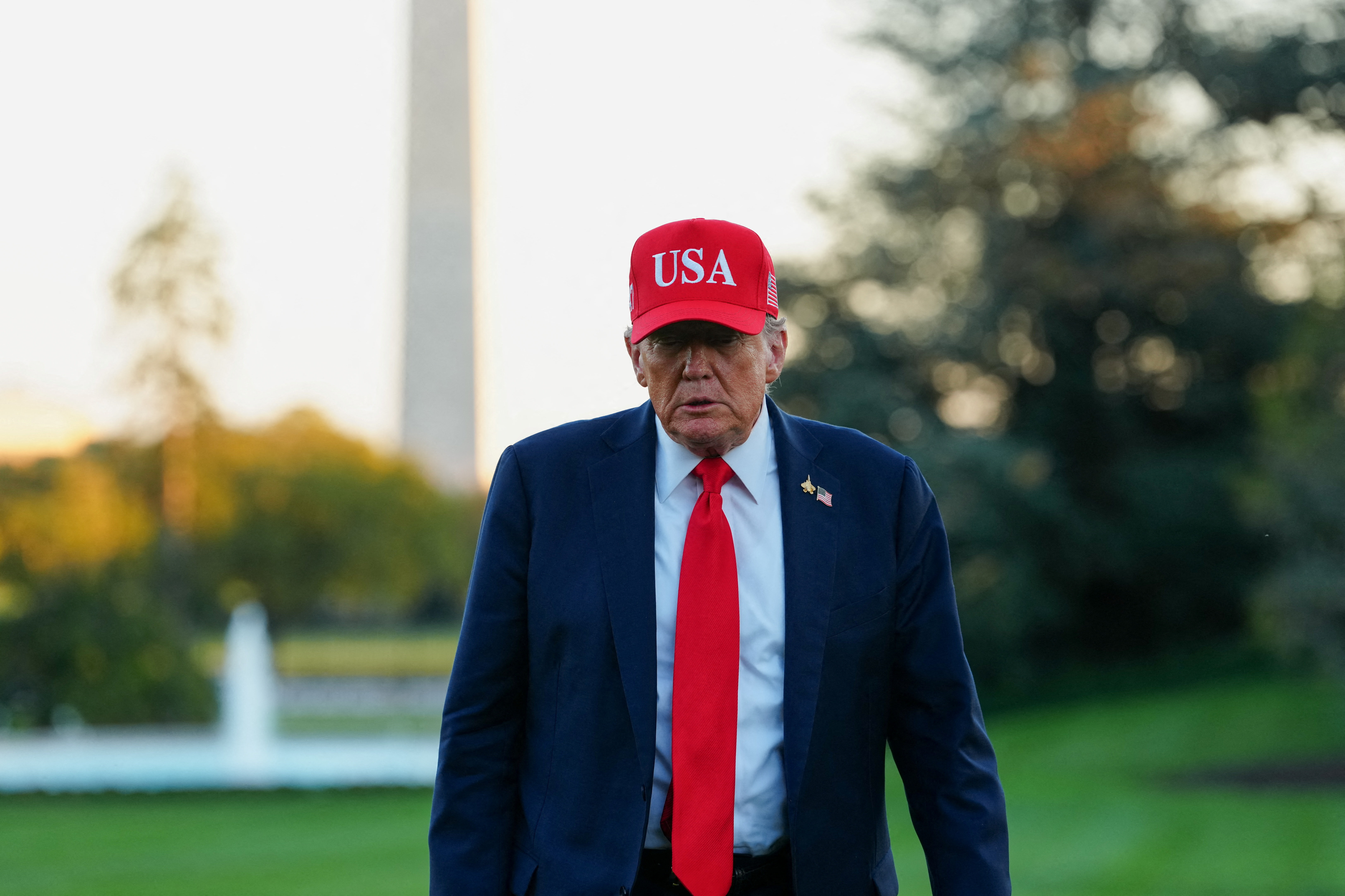 U.S. President Donald Trump returns at the White House, in Washington