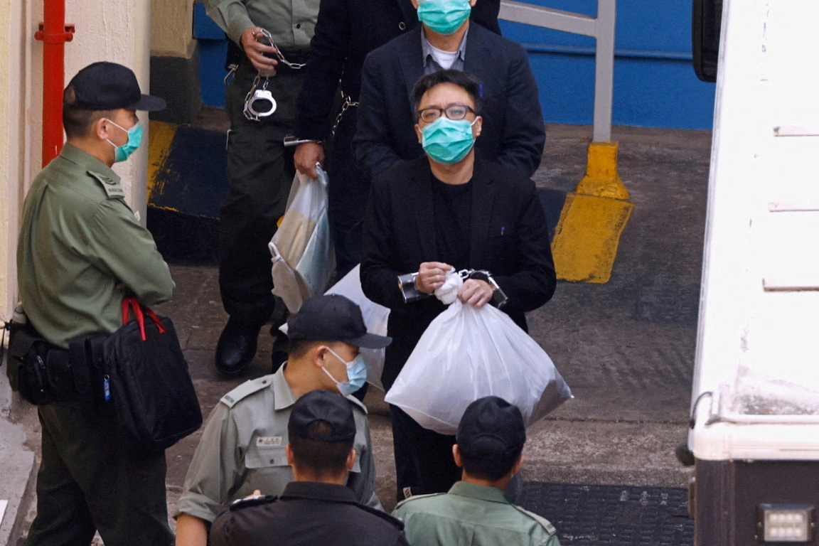 Pro-democracy activist Tam Tak-chi walks to a prison van to head to court, over national security law charges, in Hong Kong