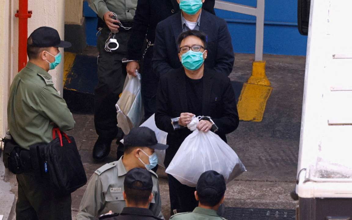 Pro-democracy activist Tam Tak-chi walks to a prison van to head to court, over national security law charges, in Hong Kong
