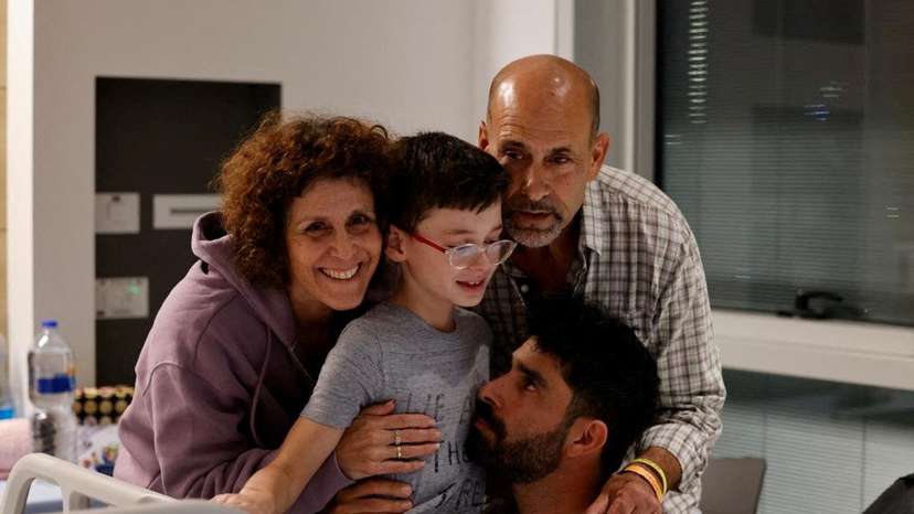Ohad Munder, 9-year-old, reacts as he meets with his family members after he returned to Israel