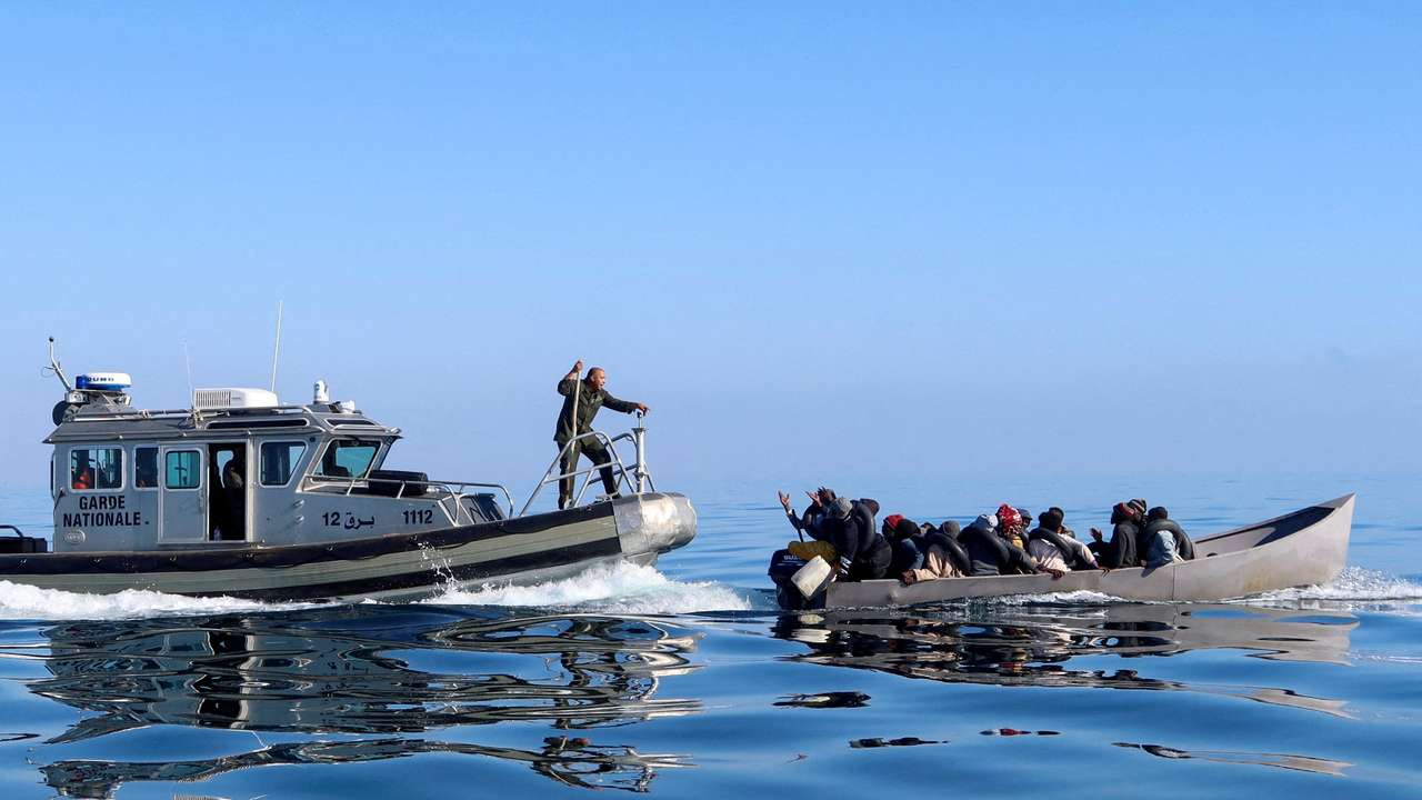 FILE PHOTO: Tunisian coast guards try to stop migrants at sea, off Sfax