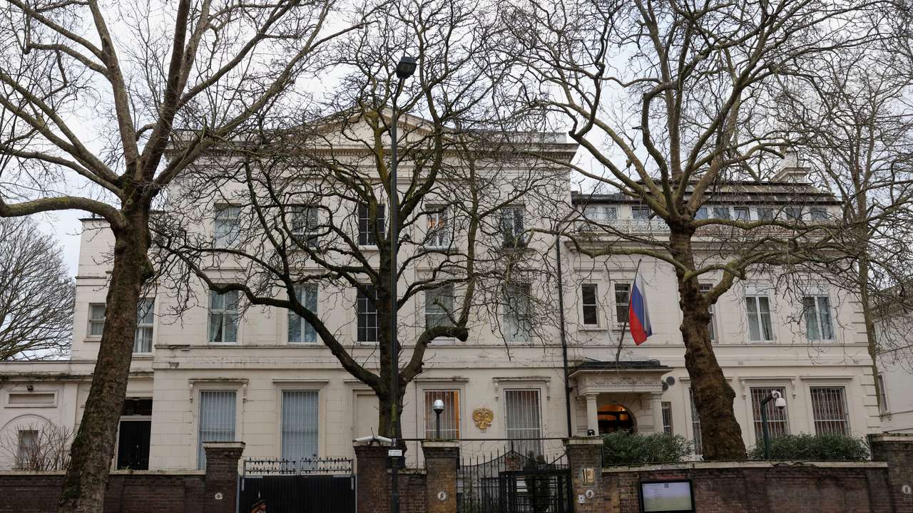 A pedestrian walks past the Russian Embassy following the death of Alexei Navalny, in London