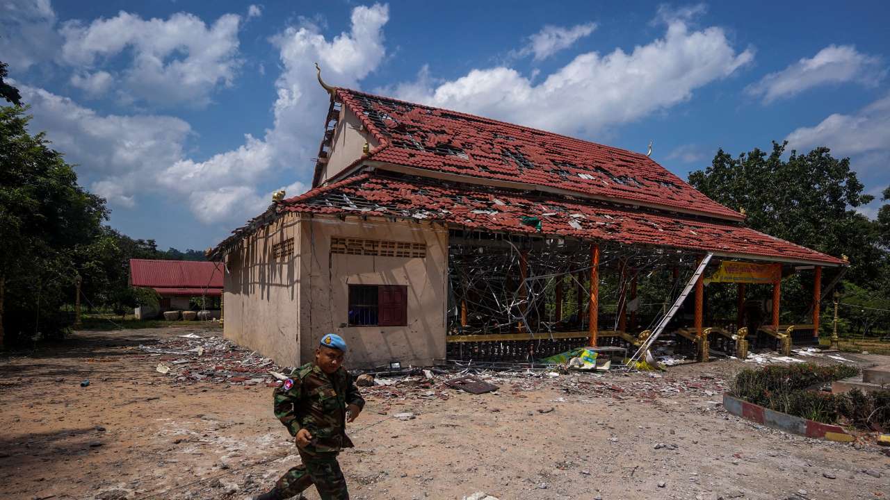 FILE PHOTO: A Cambodian soldier walks past a damaged building during a visit of delegation of foreign diplomats to inspect a damaged area along the Thailand-Cambodia's border