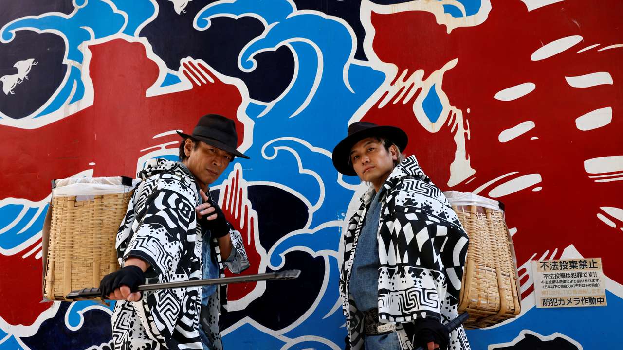 Keisuke Naka and Ikki Goto, members of Gomihiroi Samurai pick up trash on the street in Tokyo