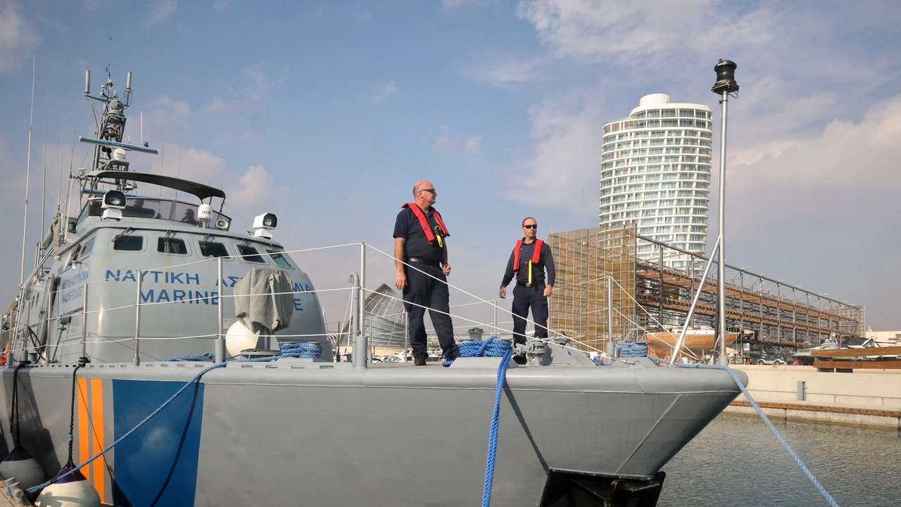 Officers stand on a Cyprus Port and Marine Police vessel in Ayia Napa Marina