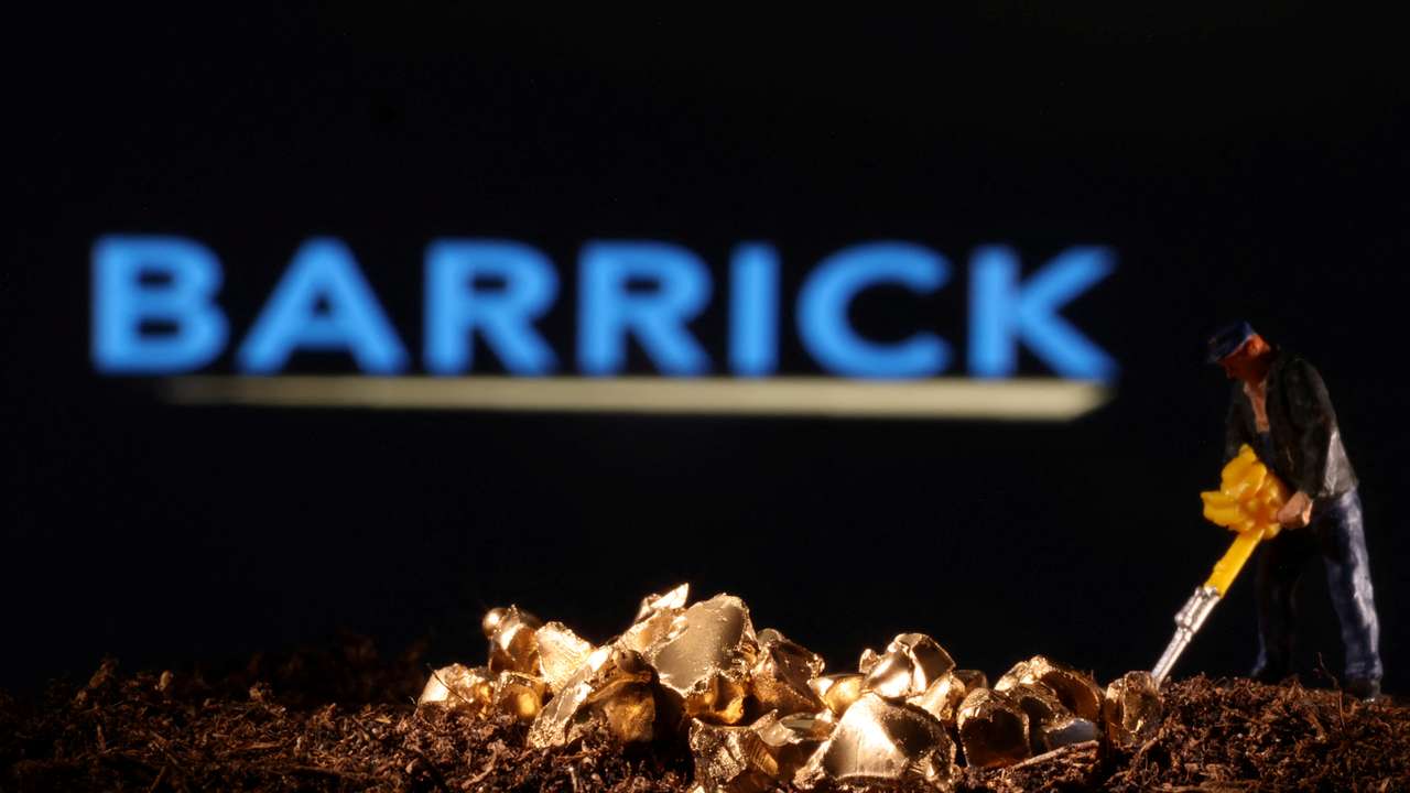 FILE PHOTO: Small toy figure and gold imitation are seen in front of the Barrick logo in this illustration