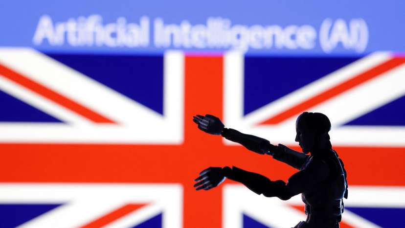 Illustration shows AI Artificial intelligence words, miniature of robot and British flag