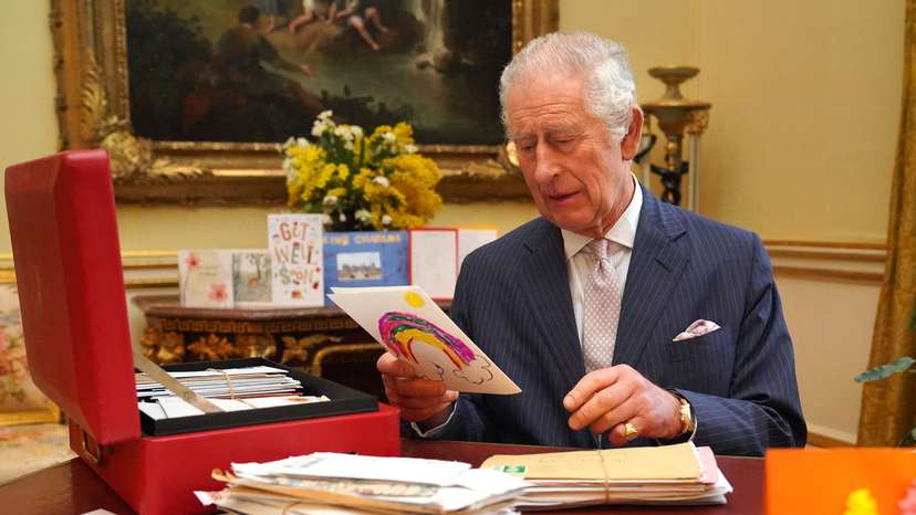 Britain's King Charles reads cards and message, in London