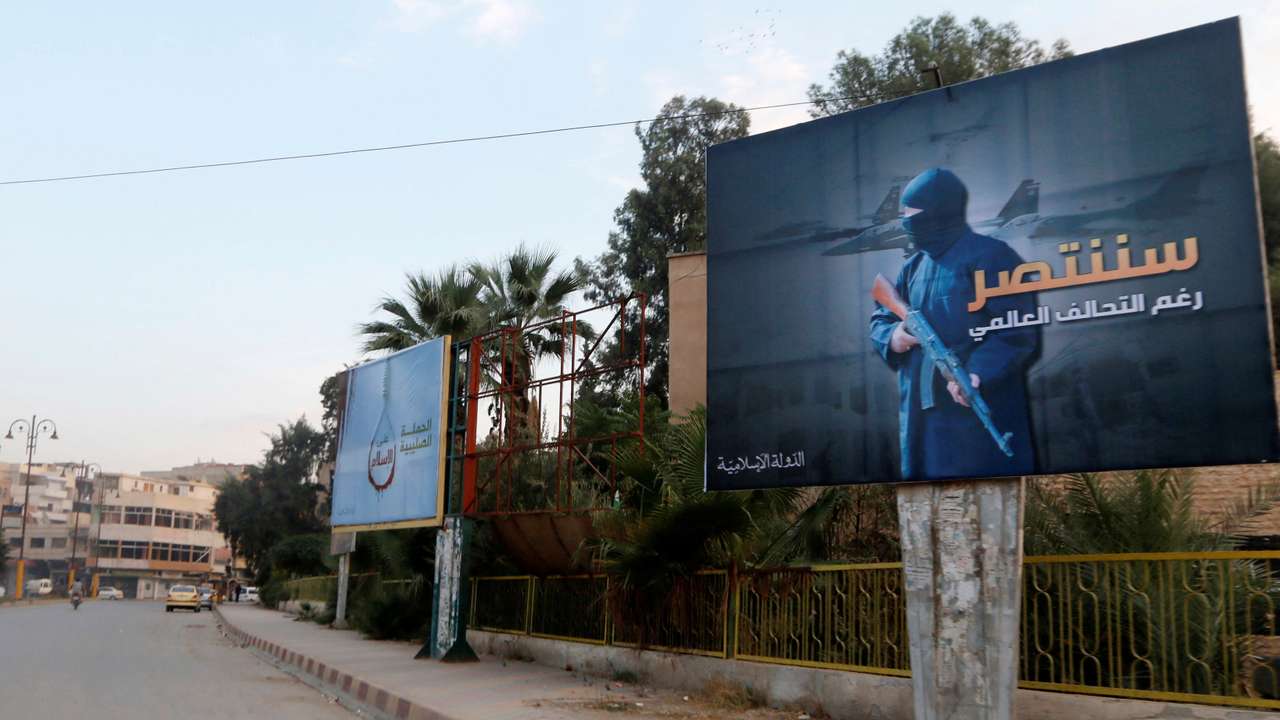FILE PHOTO:Islamic State billboards are seen along a street in Raqqa
