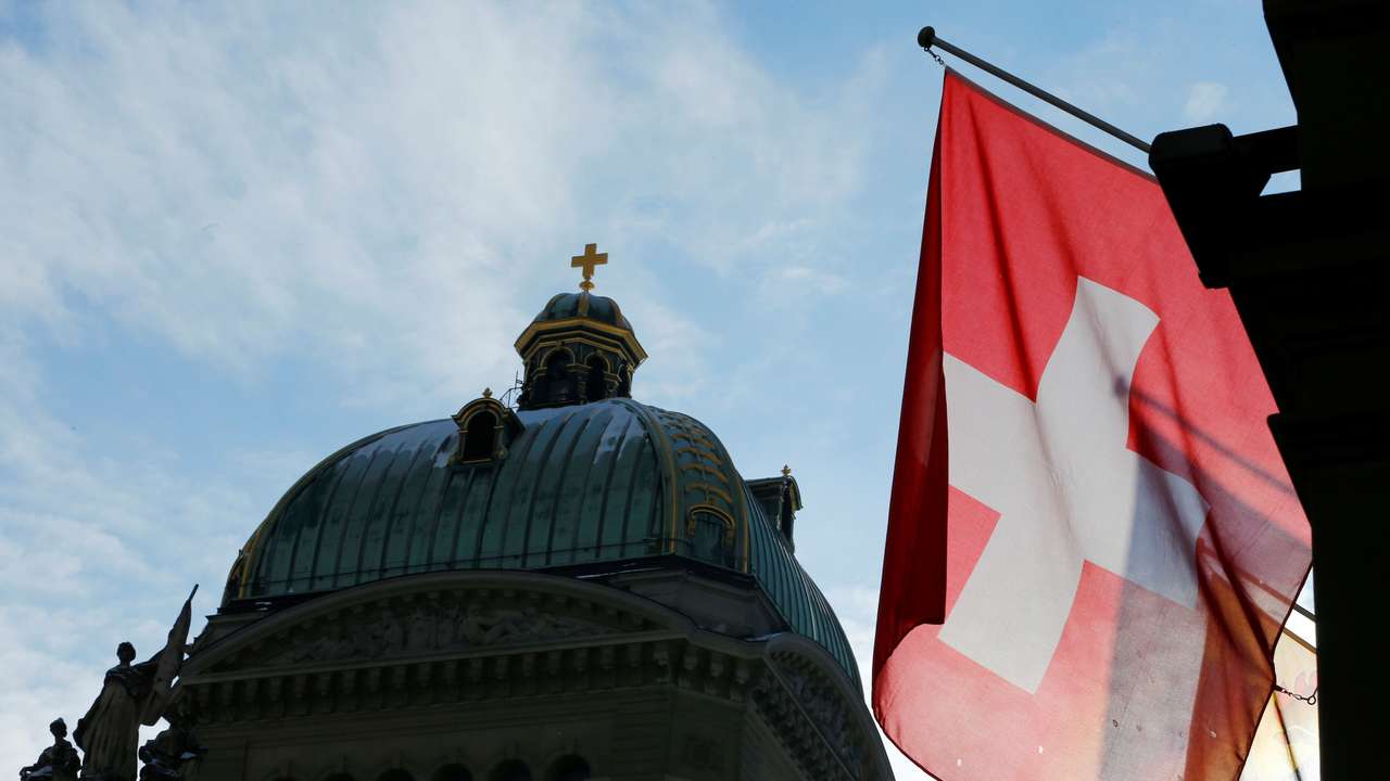 A Swiss flag is pictured in front of the Federal Palace (Bundeshaus) is pictured in Bern