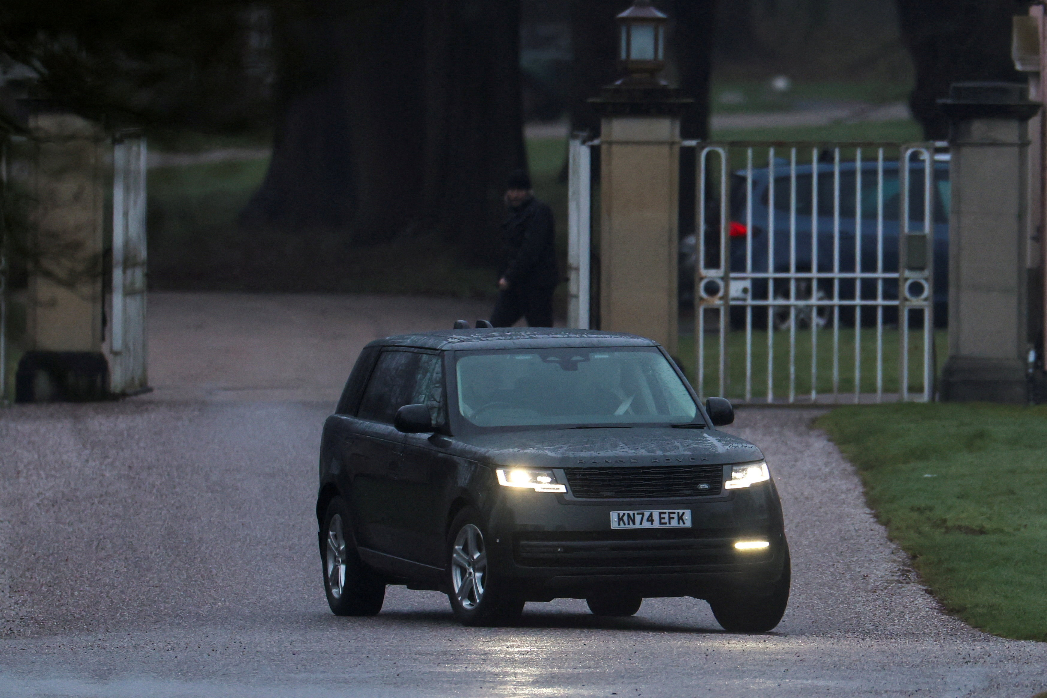 A car believed to be transporting Andrew Mountbatten-Windsor drives near a gatehouse leading to Royal Lodge