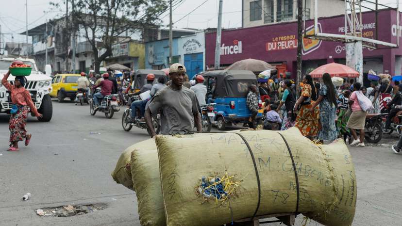 A man carries items on a handmade cart in a street of Birere market, days after the town of Goma was taken by M23 rebels