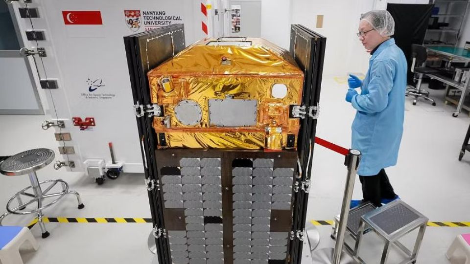 NTU Satellite Research Centre Executive Director Lim Wee Seng with a final model of NTU's next satellite, named Elite. PHOTO: THE STRAITS TIMES