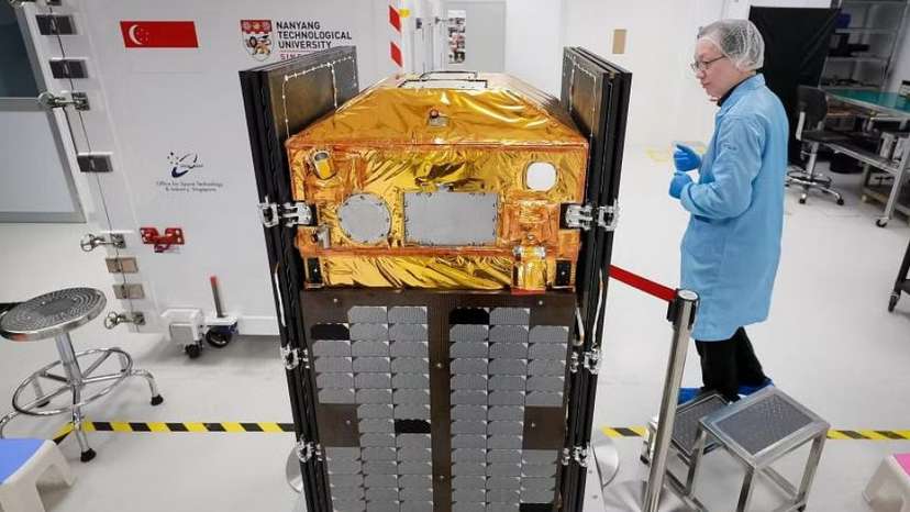 NTU Satellite Research Centre Executive Director Lim Wee Seng with a final model of NTU's next satellite, named Elite. PHOTO: THE STRAITS TIMES