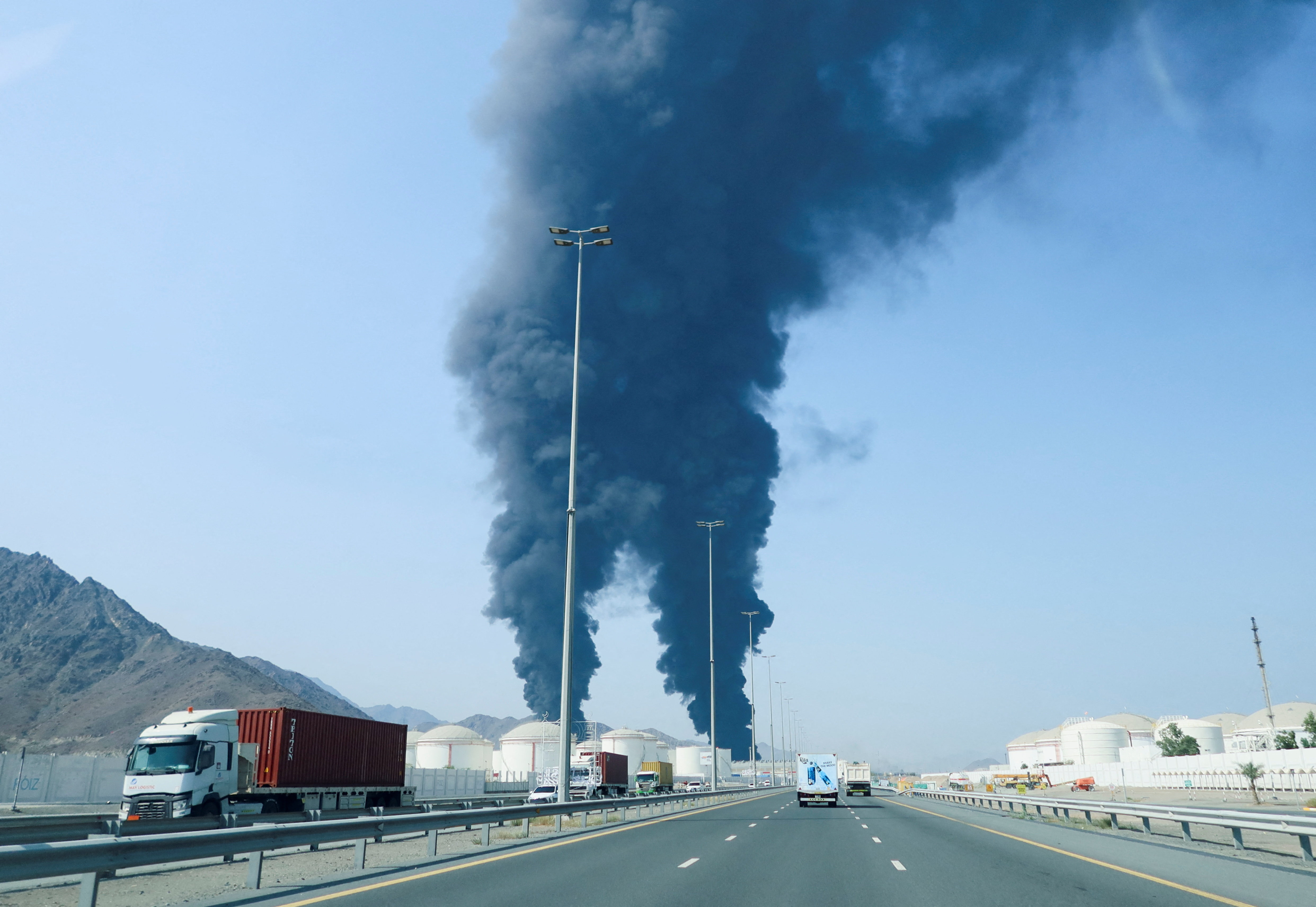Smoke rises in the Fujairah oil industry zone, caused by debris after interception of a drone by air defenses, according to the Fujairah media office, amid the U.S.-Israel conflict with Iran, in Fujairah