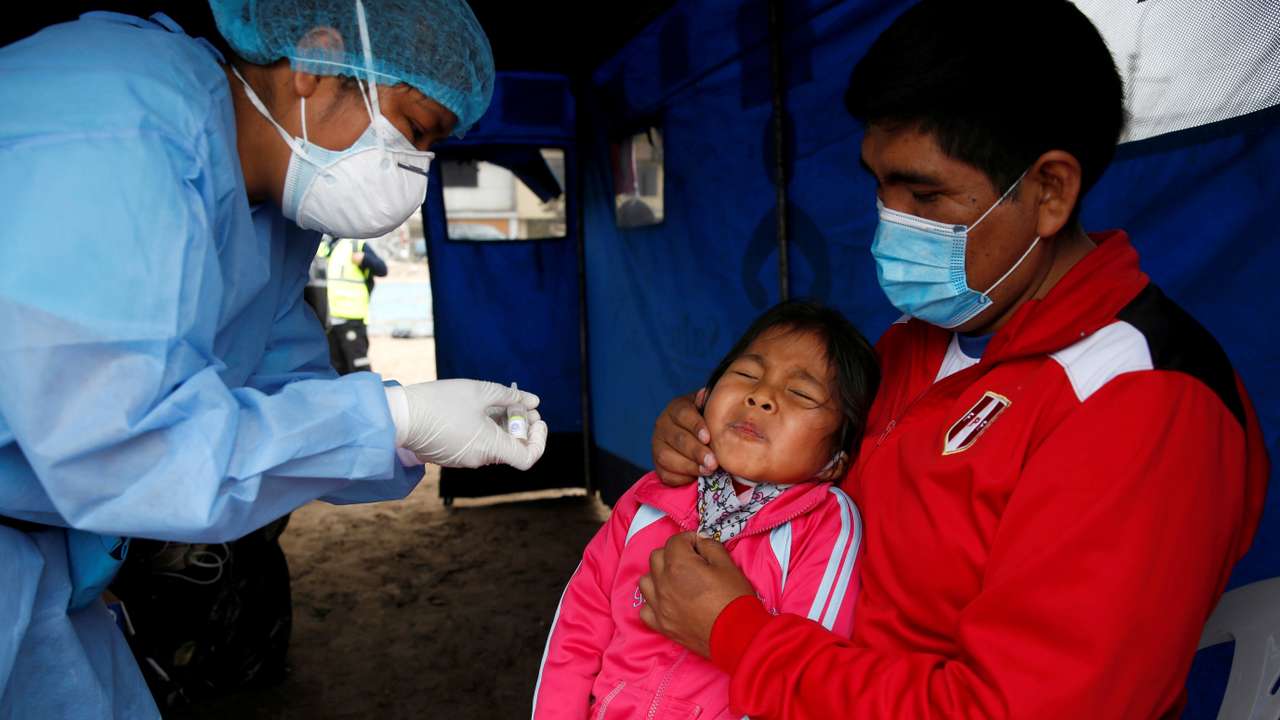 A little girl reacts after receiving an oral vaccine during a vaccination drive for diphtheria, influenza, tetanus and pneumococcus, after several new cases of diphtheria were identified, in Lima