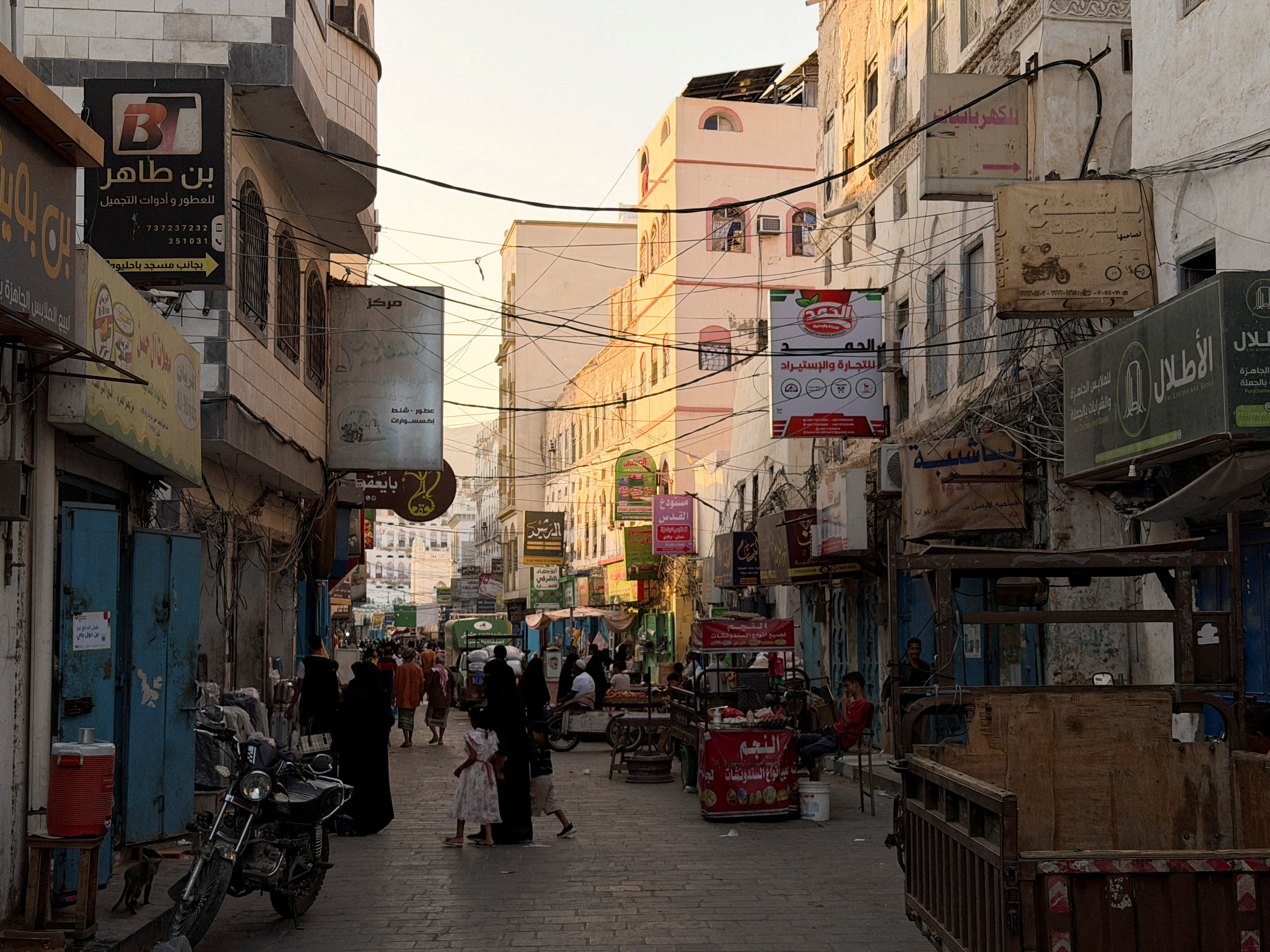 FILE PHOTO: People walk through a traditional market in the port city of Mukalla